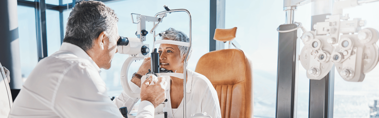 Picture shows optometrist examining patient's eye